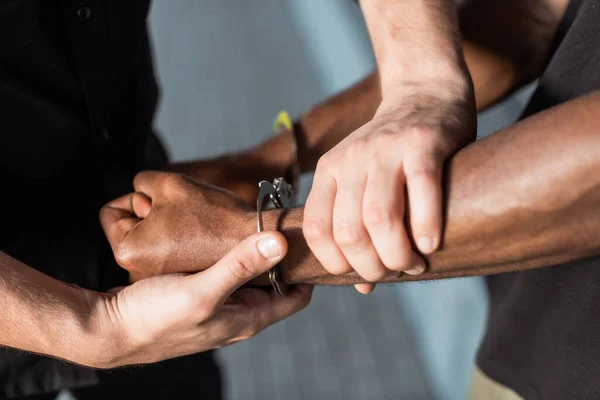 depositphotos 386965084 stock photo cropped view policeman touching hand